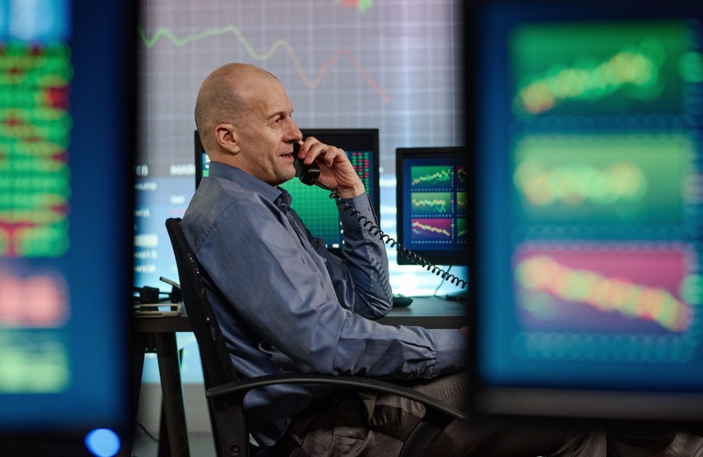 Business man talking on his Voice Over IP (VoIP) Telephone.