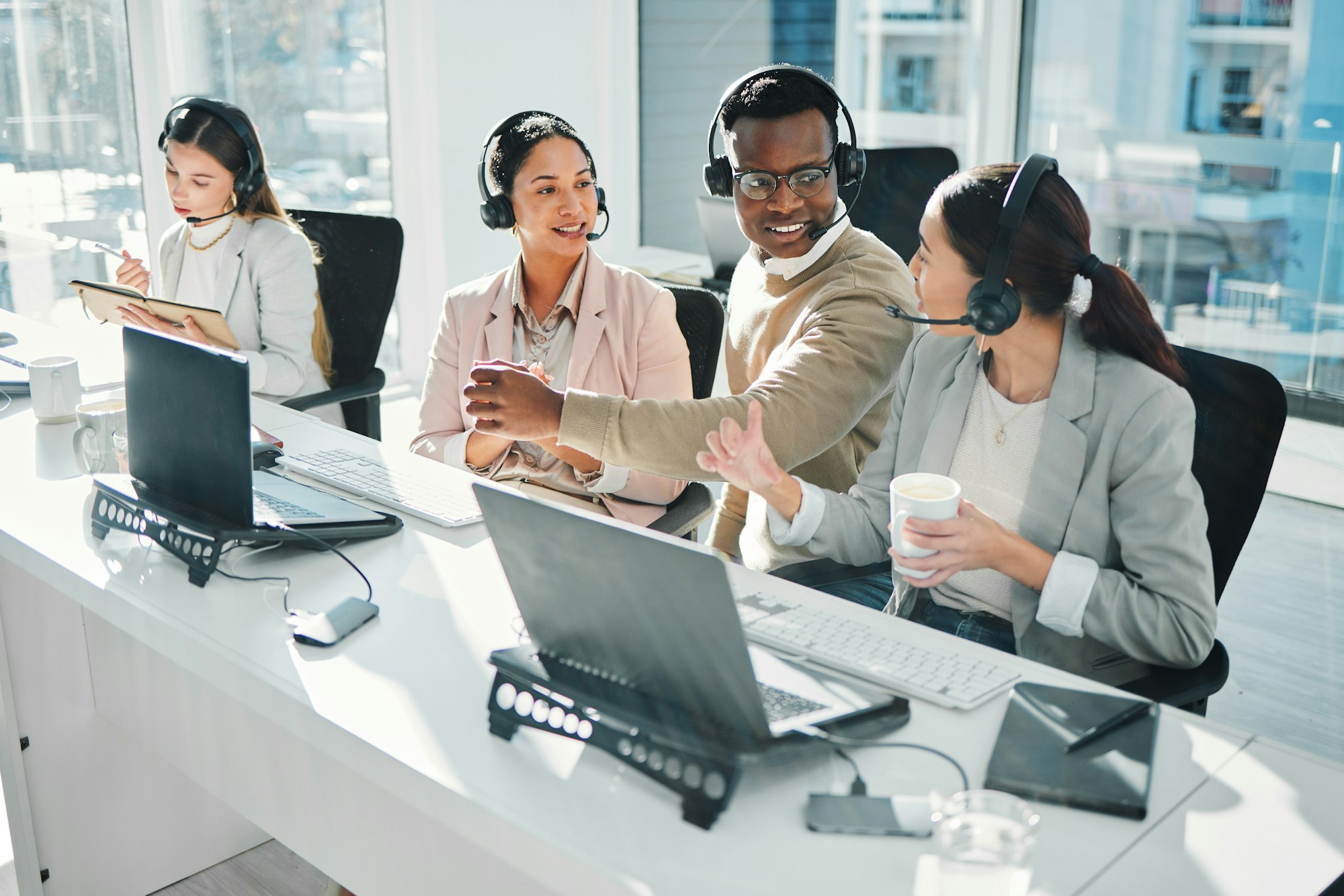 Call center staff demonstrating the Advantages of switching to VoIP